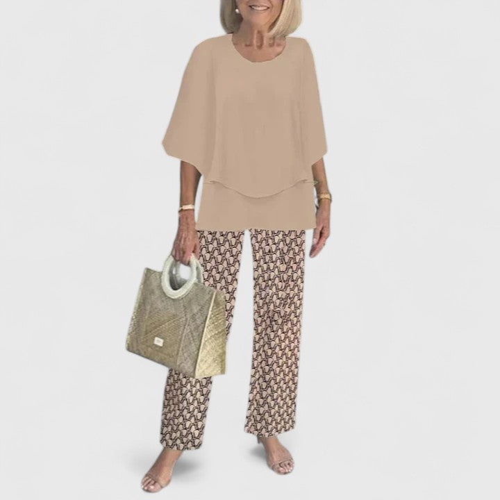 Flowy fabric women's elegant floral print two-piece set with layered top and wide leg trousers.