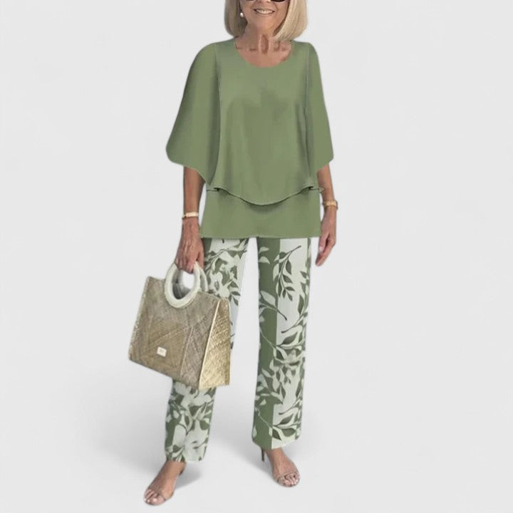 Elegant women's layered top and wide leg floral print trousers set, perfect for smart casual events.