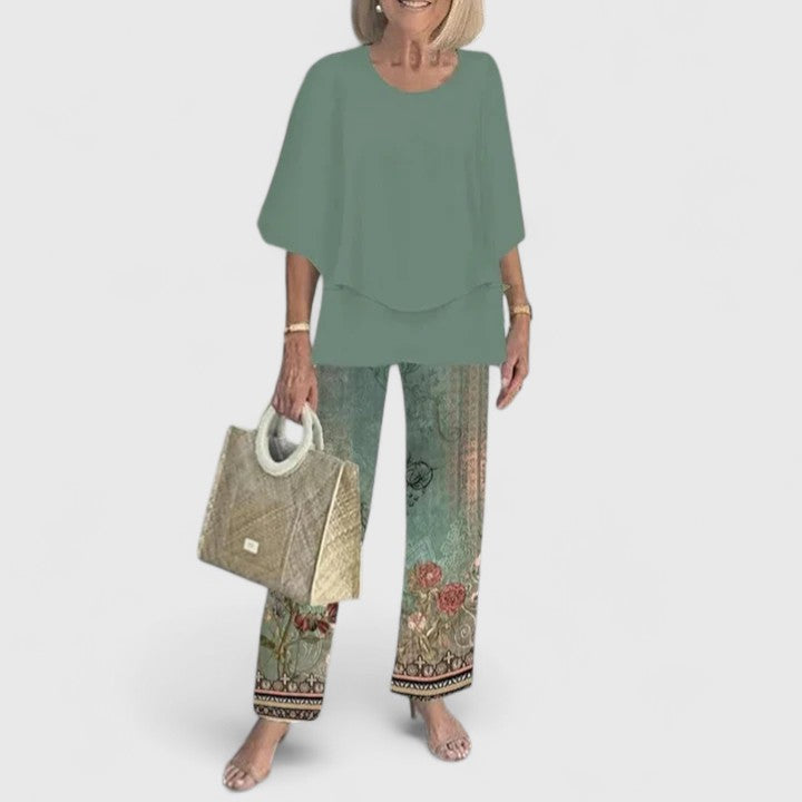 Stylish women's floral print two-piece set featuring a layered top and flowy wide leg trousers.