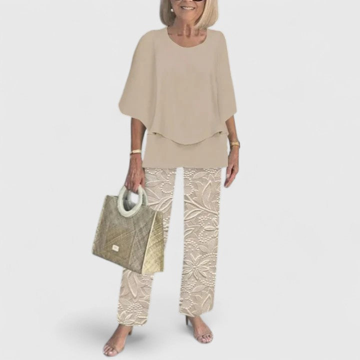 Women's elegant floral print coordinating top and wide leg trousers set for summer fashion.