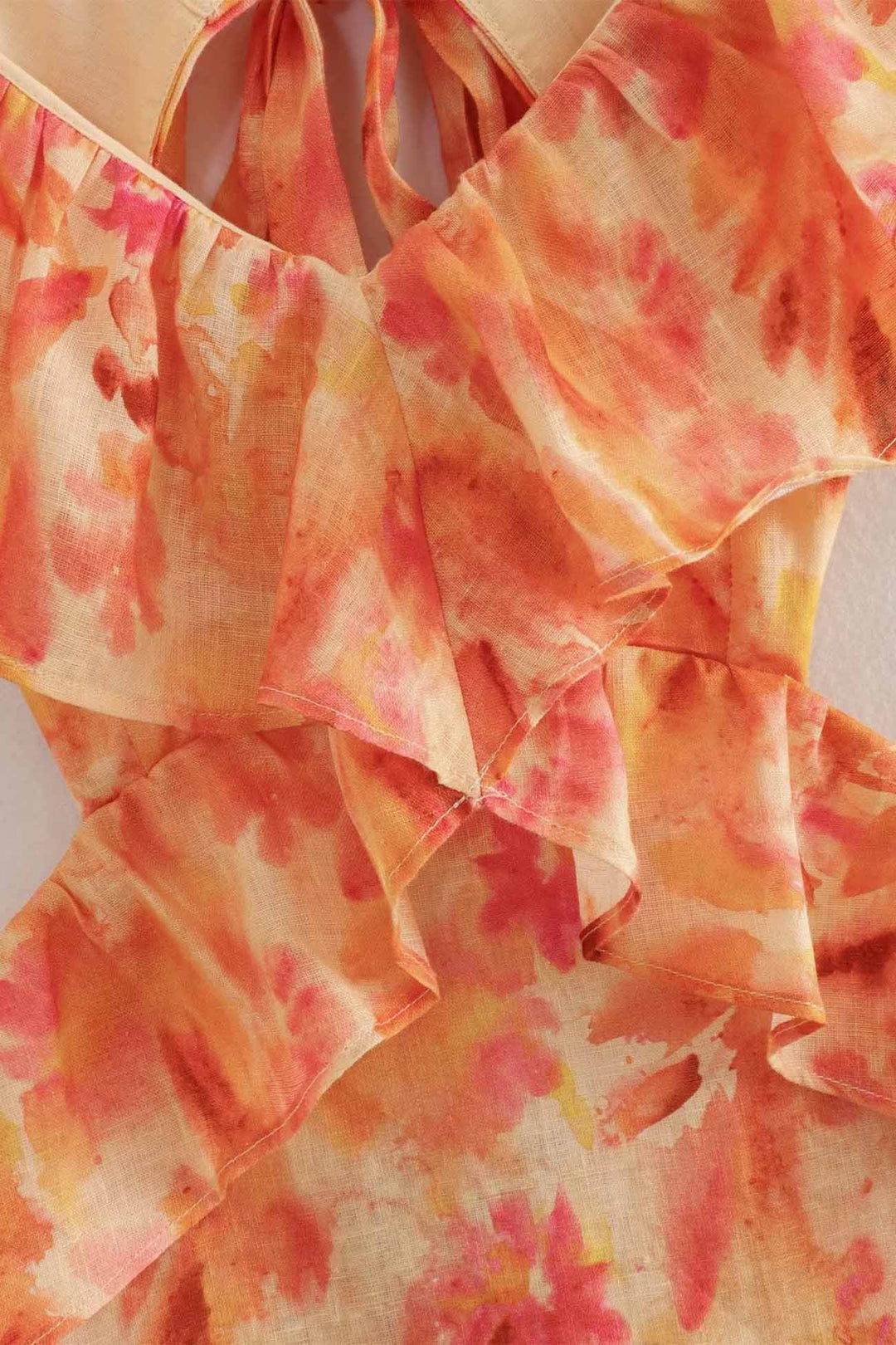 Close shot of the fabric detail of the women's floral ruffle maxi dress, showing high quality.