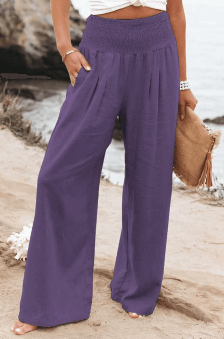 Flowy wide-leg palazzo pants for women, boho elegant. Comfortable summer beachwear, high-waist style.