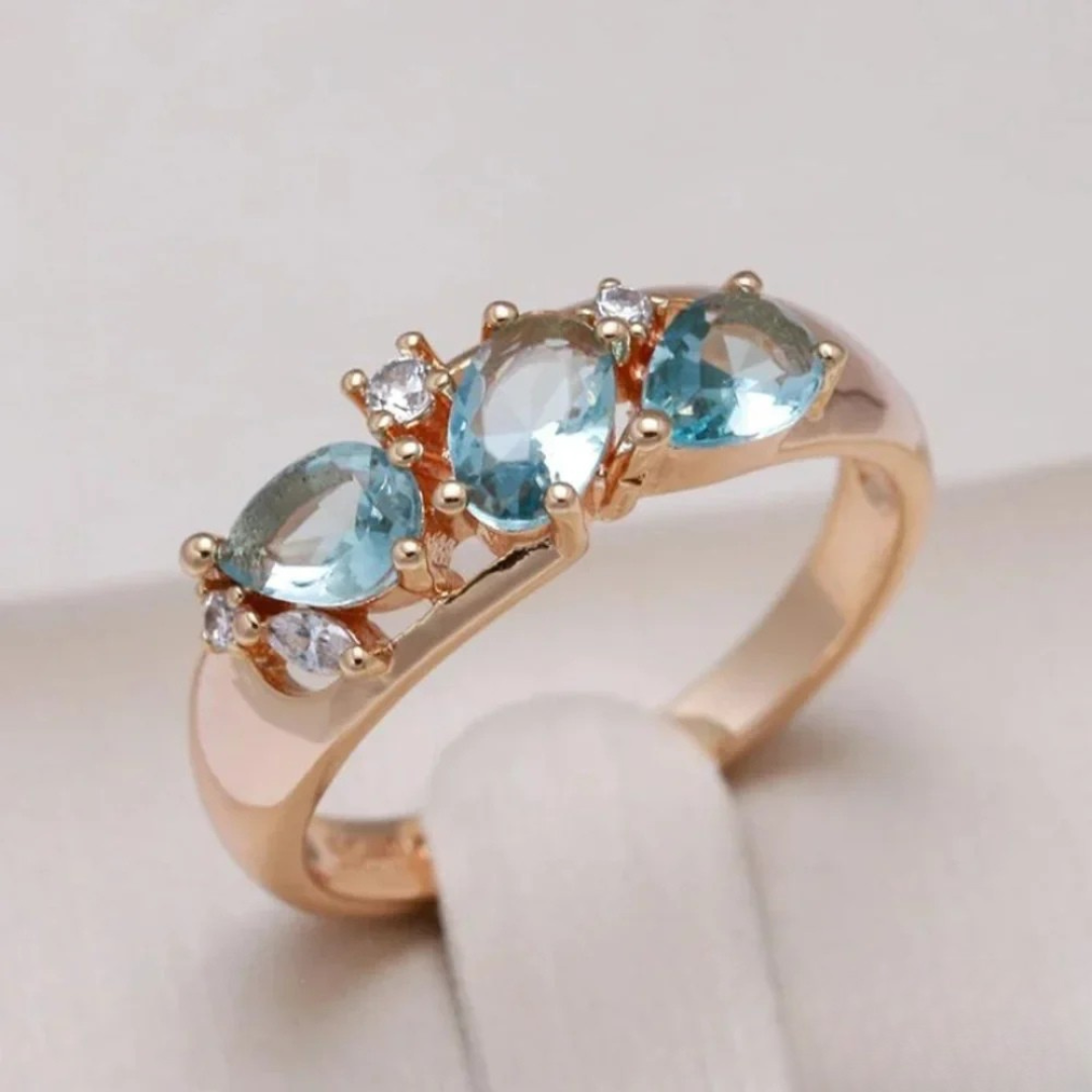 Women's elegant gold ring with a radiant blue zirconia stone. A beautiful fashion ring, perfect for any occasion or gift.