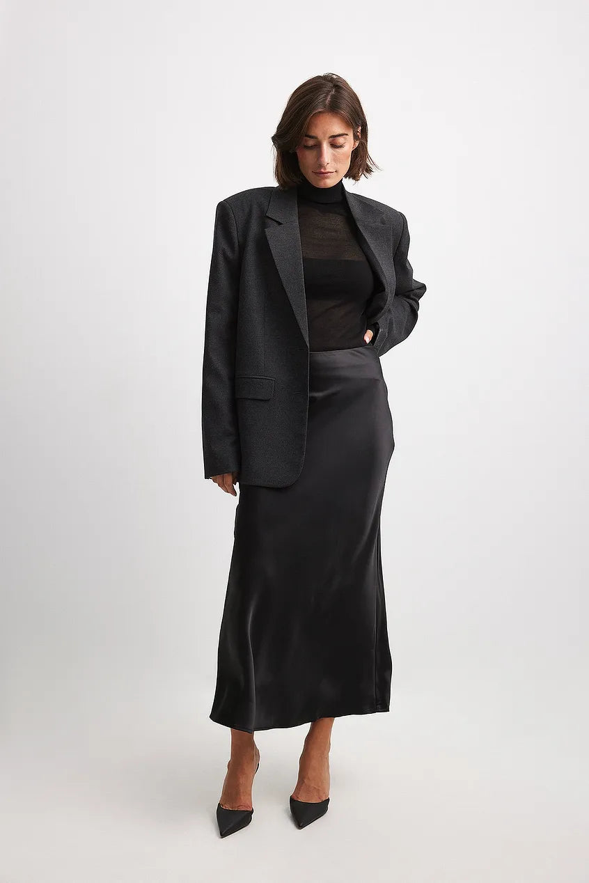 Women's elegant high-waisted flowing midi skirt, versatile for formal and casual fashion apparel.