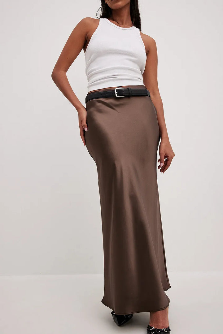 Feminine high-waisted flowing midi skirt, elegant satin-finish, versatile for various women's fashion.