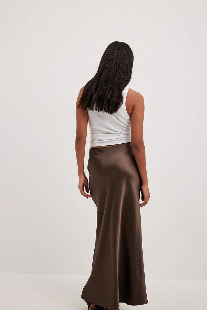 Full-length view of a women's high-waisted flowing midi skirt, elegant and versatile fashion apparel.
