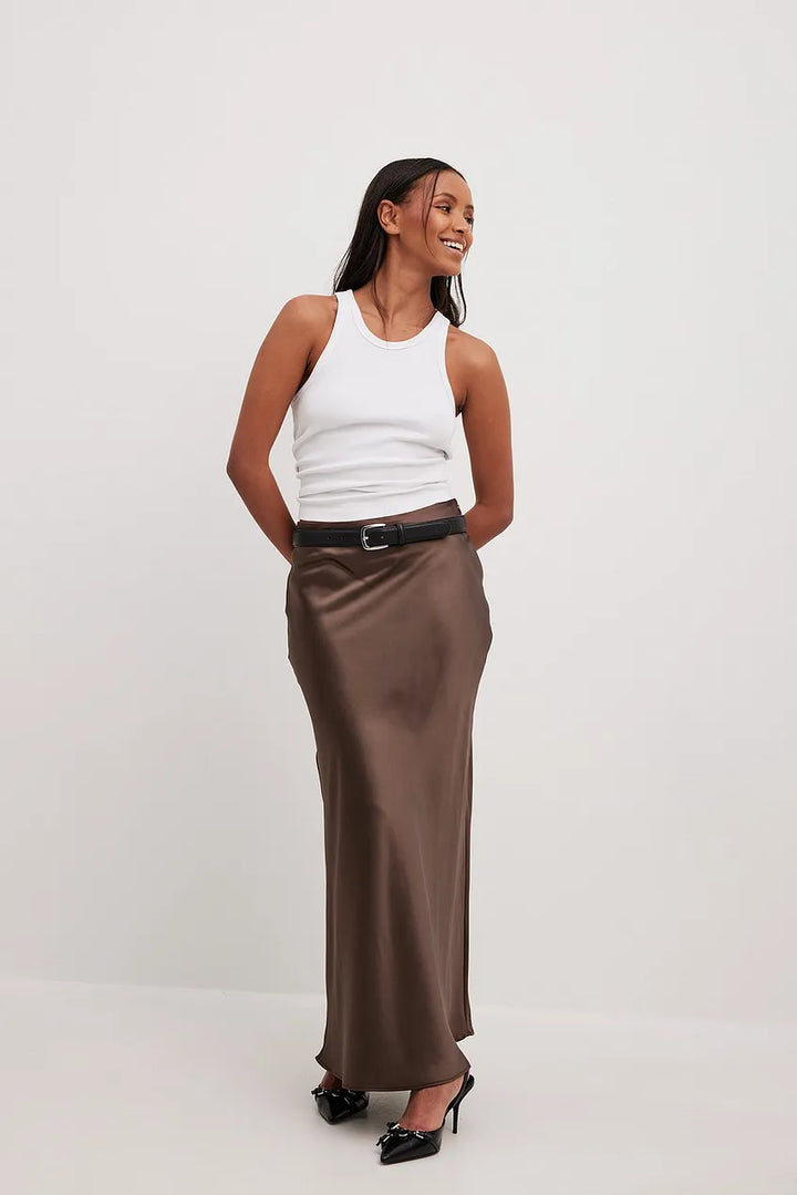 Women's high-waisted flowing midi skirt, styled for an elegant, feminine, and versatile fashion statement.