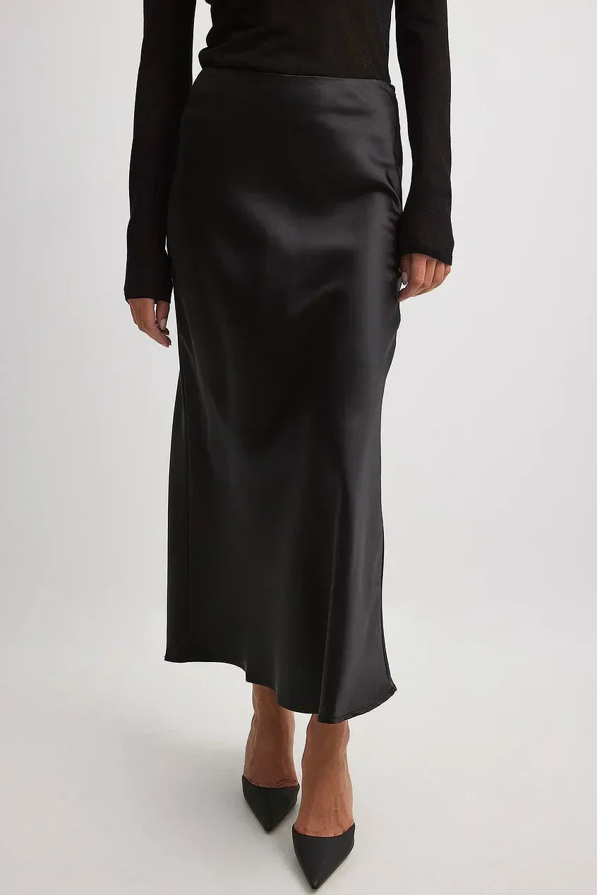 Feminine satin-finish high-waisted midi skirt, flowing design for women's elegant and comfortable wear.