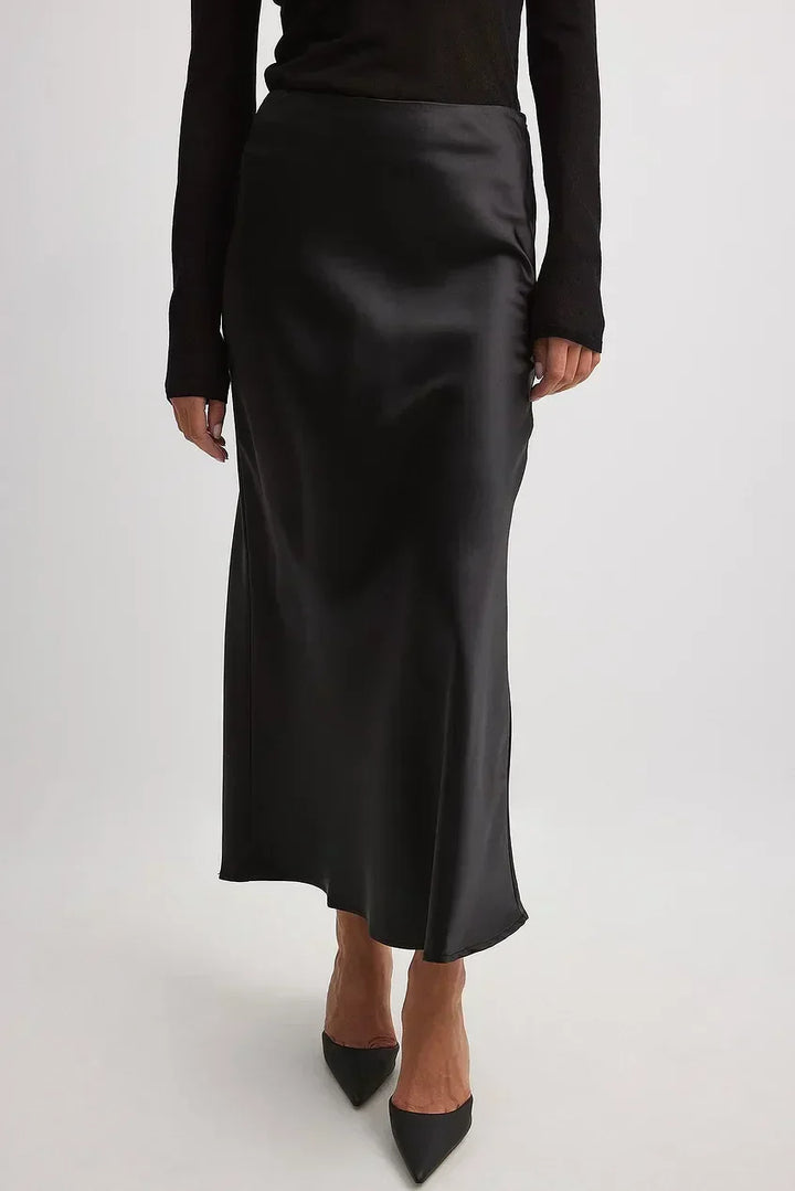 Feminine satin-finish high-waisted midi skirt, flowing design for women's elegant and comfortable wear.