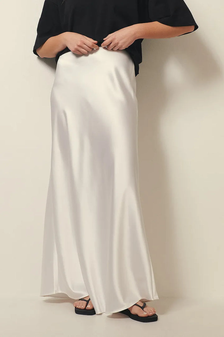 Women's flowing midi skirt, high-waisted for a flattering fit, elegant and versatile for modern apparel.