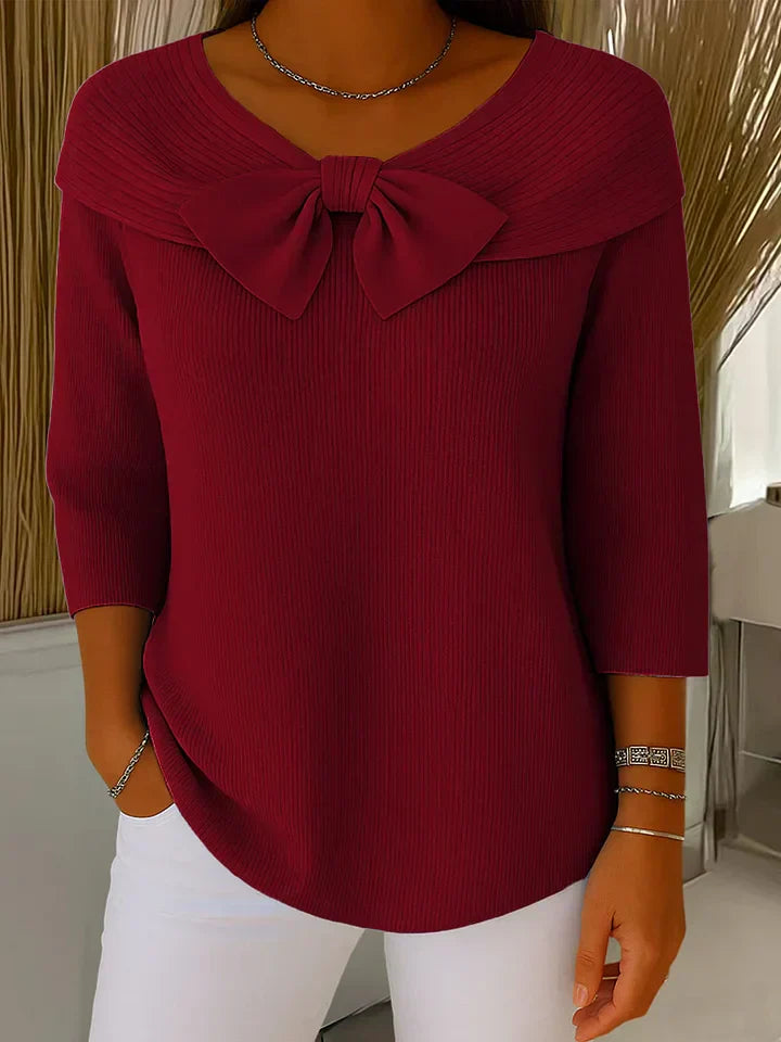 Chic women's autumn sweater with elegant bow detail, a flattering and comfortable knit top.
