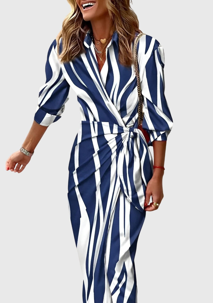Flattering silhouette of a women's elegant long sleeve printed wrap midi dress. Versatile for spring & summer fashion.