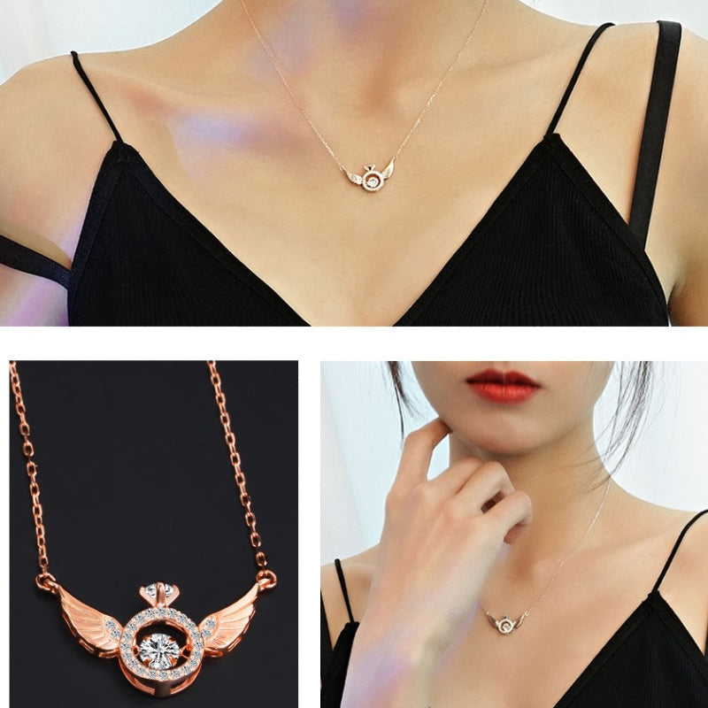 Close-up of a women's titanium steel angel wing necklace in rose gold, elegant jewelry.