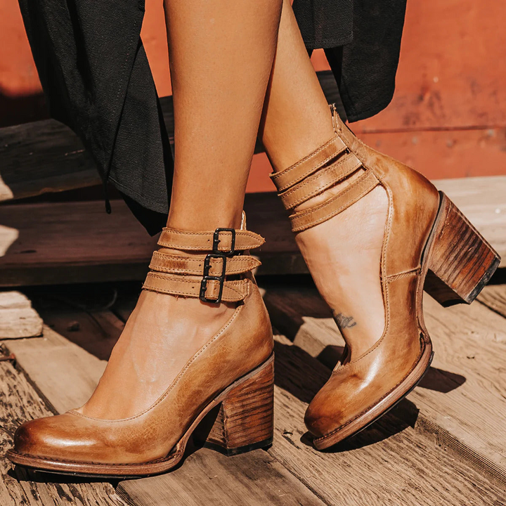 Fashionable women's block heel pumps. Features a comfy round toe & adjustable ankle strap. Ideal elegant workwear shoes.