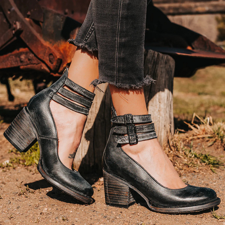 Close-up of a women's round toe pump with a stable block heel & sleek ankle strap. Classic, versatile dress footwear.