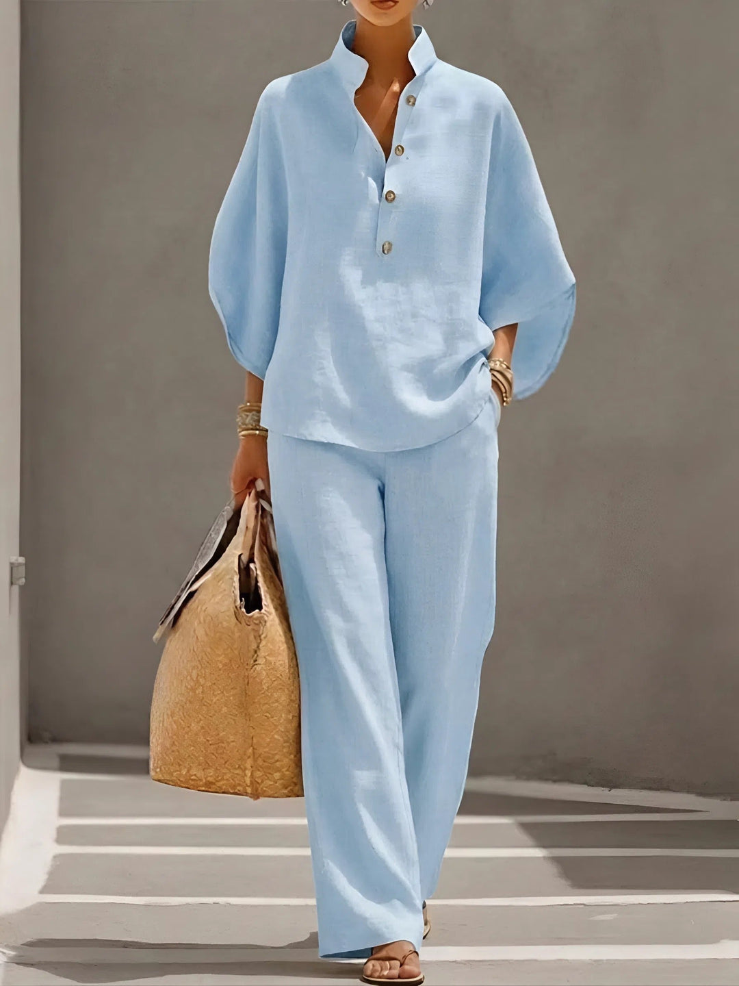 Resort wear women's set: Mandarin collar kimono sleeve top & flowy wide leg pants for a chic summer look.