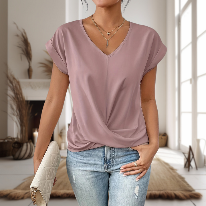 Stylish women's V-neck top with unique twisted hem detail. Perfect for casual chic everyday wear or office.