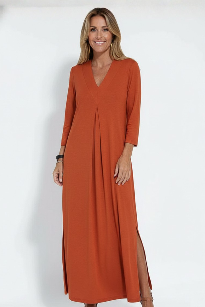 Close-up of the flattering V-neck and subtle side slit detail on a women's elegant summer maxi dress.