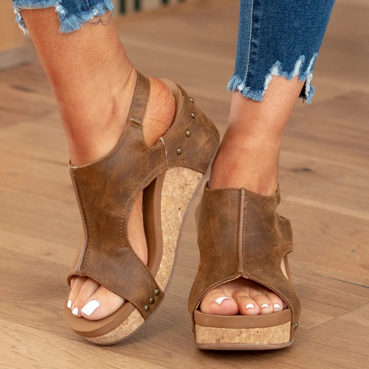 Stylish women's wedge sandals with a supportive sole, ensuring all-day comfort & elegance.