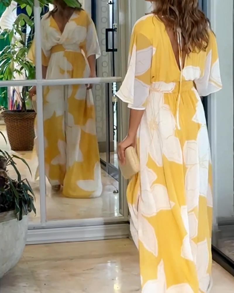 Stunning yellow floral maxi dress for women, boasting a flattering V-neck, flutter sleeves, and a comfortable flowy fit.
