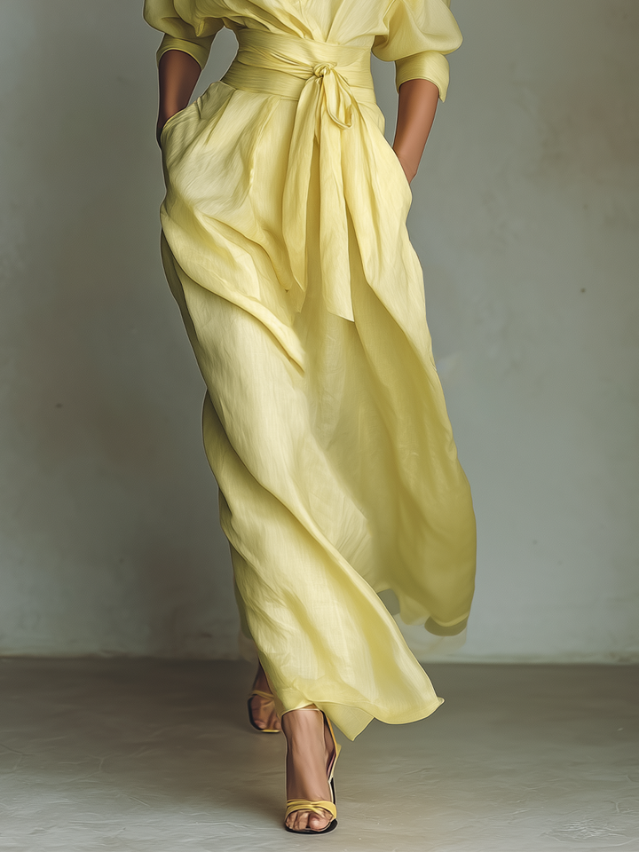 Casual elegant women's yellow maxi shirt dress. Long summer style with a tie-waist, ideal for resort fashion.