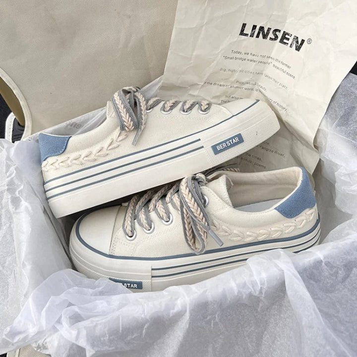 Side view of women's modern platform sneakers, lace-up, with elevated sole. Great for street style & daily wear.
