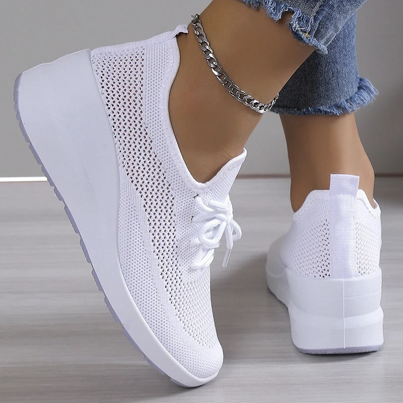 Side view of women's elevated platform wedge sneakers in a chic color, designed for comfort.