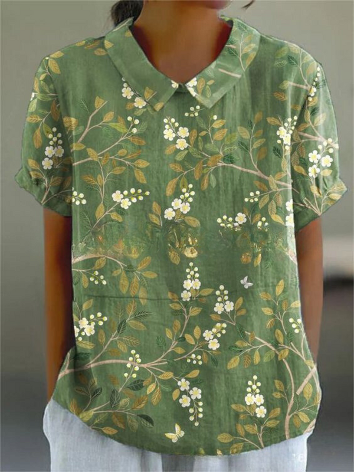 Women's versatile floral embroidered blouse featuring a delicate Peter Pan collar and short sleeves.