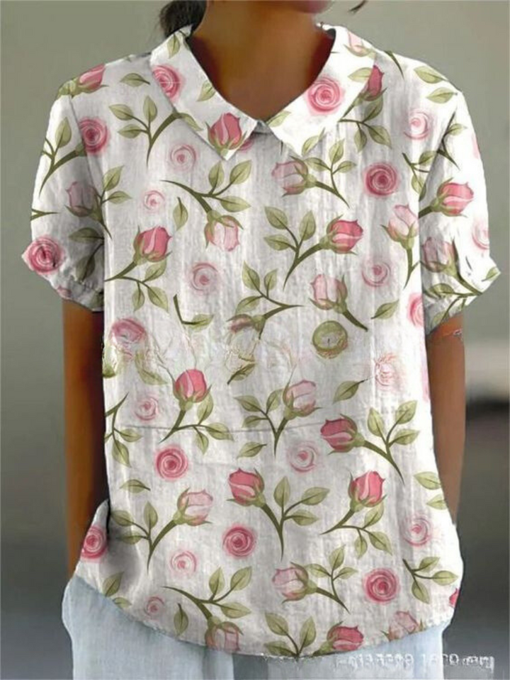 Vintage style women's blouse with delicate floral embroidery & classic Peter Pan collar, feminine spring fashion.