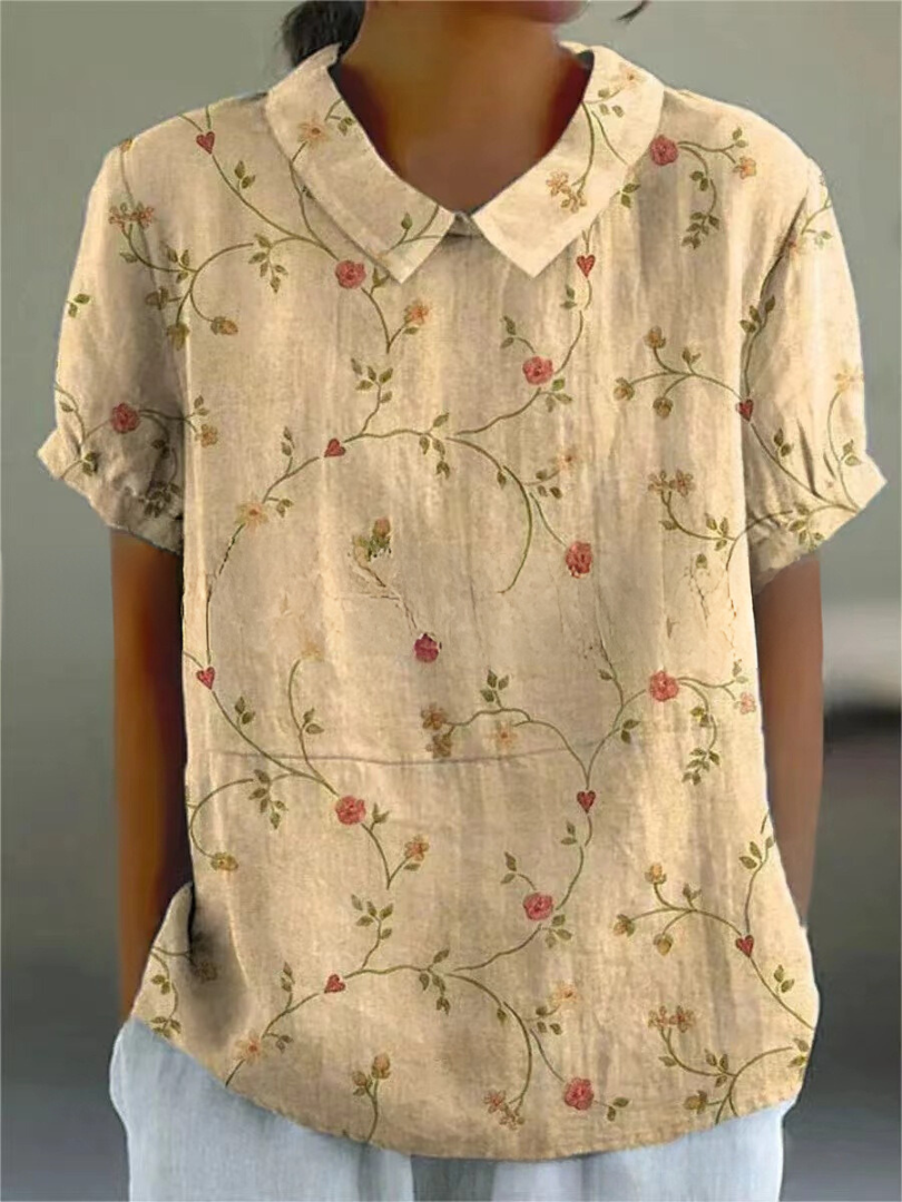 Casual chic women's summer blouse, short sleeve, with intricate floral embroidery & Peter Pan collar detail.