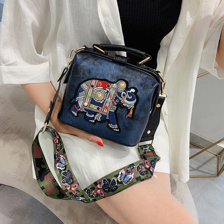 Lightweight women's crossbody bag with intricate mandala embroidery, versatile cotton fabric.