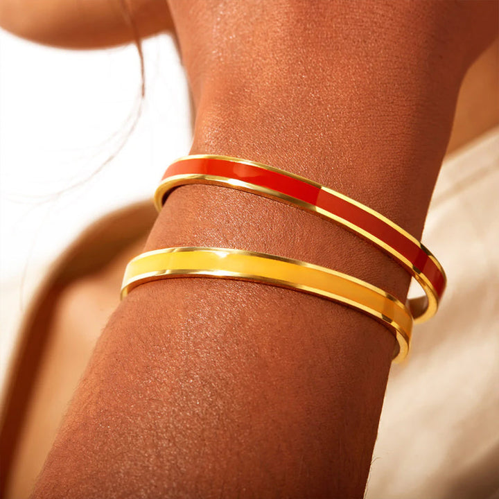 Woman's hand wearing a delicate engraved stainless steel bangle, a chic wrist accessory