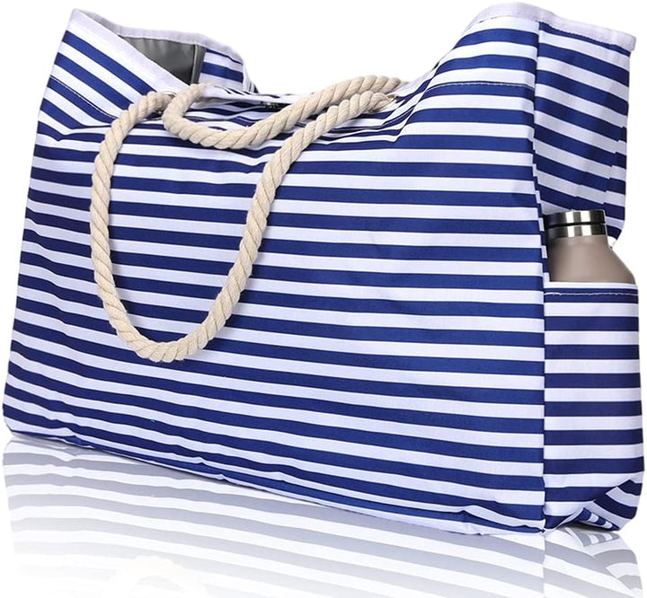 Women's extra large waterproof beach tote bag on sand, ready for a sunny summer day.