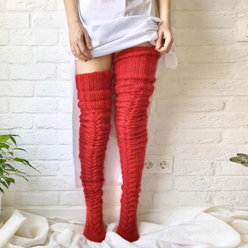 Cozy women's winter over-knee socks, extra long and intricately knitted for maximum warmth and style.