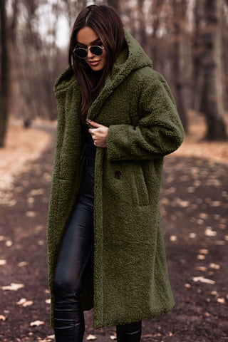 Stylish women's long winter parka coat with a luxurious faux fur trimmed hood, side view