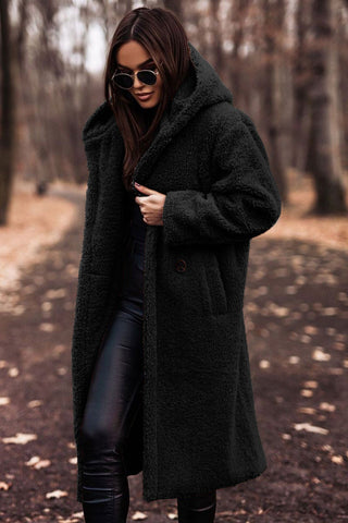 Detail shot of the durable zipper and snap closure on a women's long winter outerwear coat