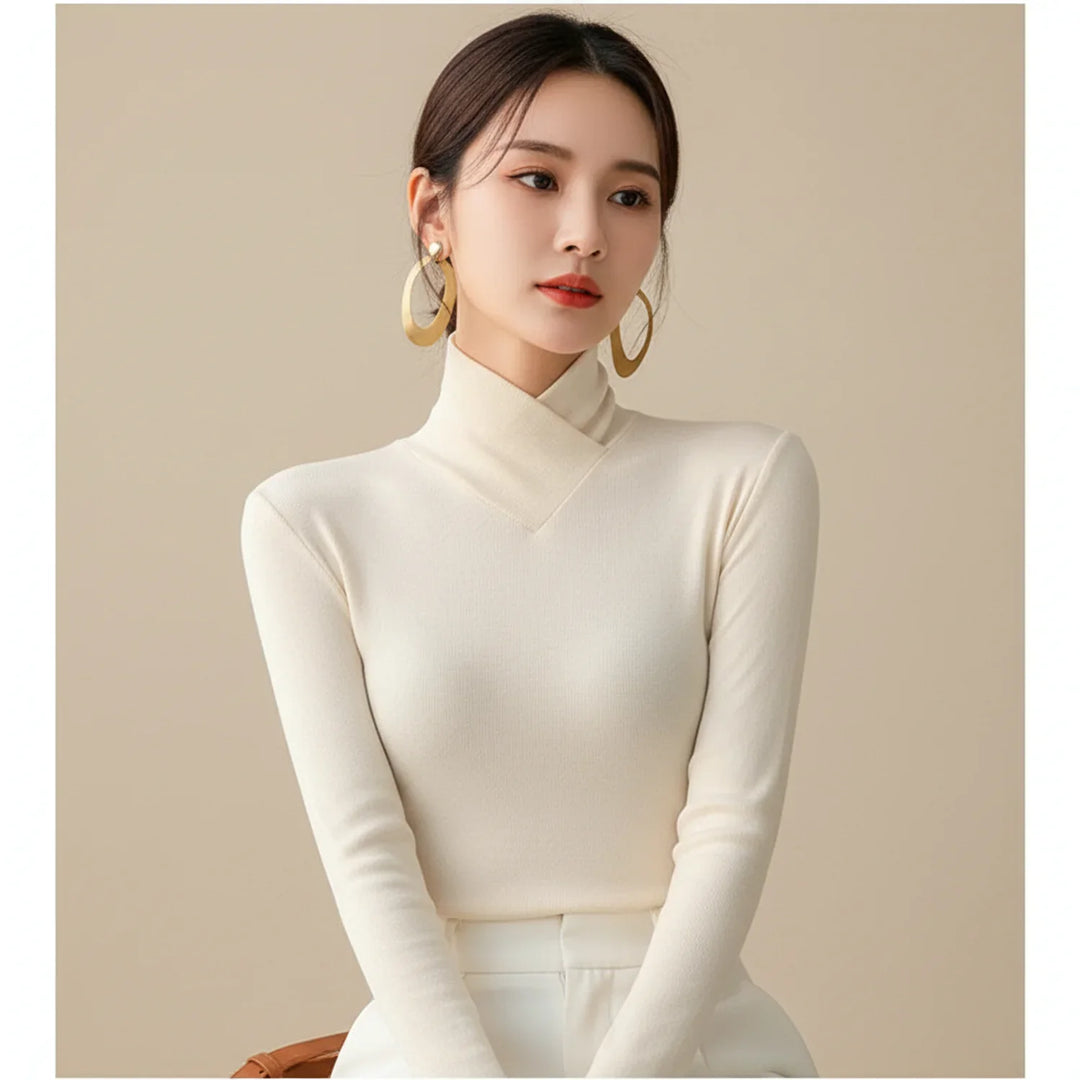 Cozy women's fitted turtleneck sweater with long sleeves, ideal for fall/winter layering. Versatile for casual or elegant style.