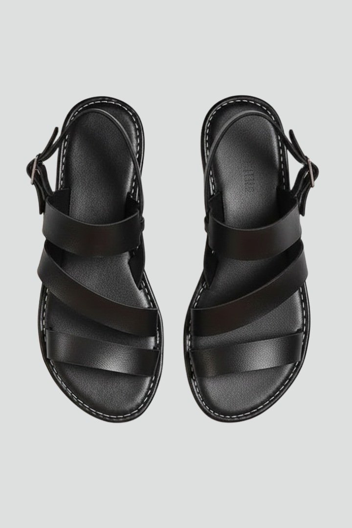 Women's flat sandals with secure back strap for comfortable everyday summer wear.