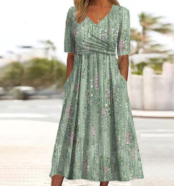 Women's flattering green midi summer dress with flared skirt, v-neck, short sleeves & elegant print. Perfect for warm weather.