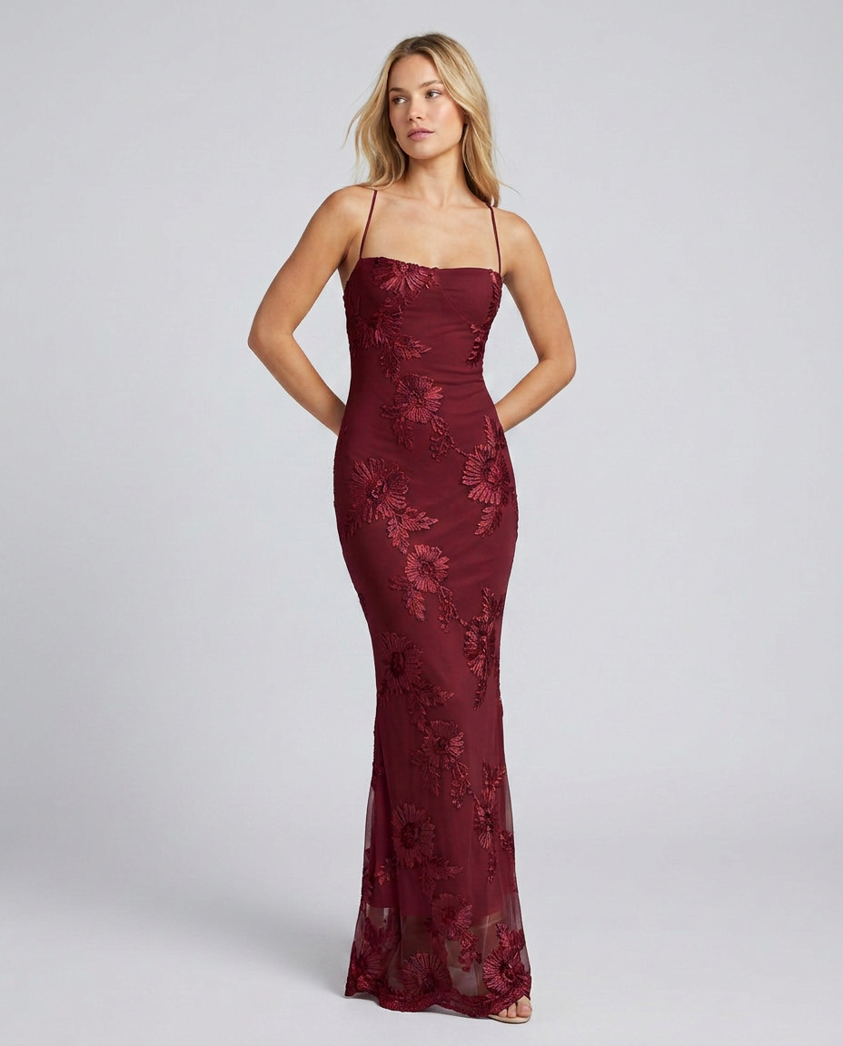 Women's evening floral gown with intricate appliqué details and an alluring lace-up back design.