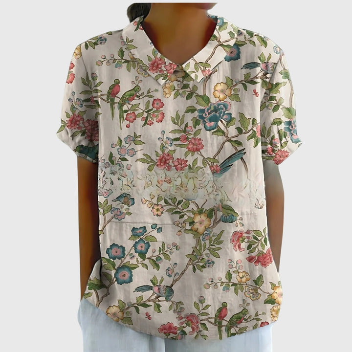 Back view of a comfortable women's floral blouse, showcasing the relaxed fit and elegant design.
