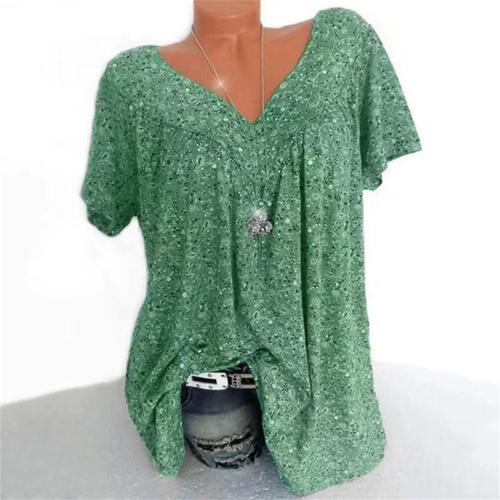 Feminine floral print women's blouse, V-neck and flutter sleeves, great for vacation style.