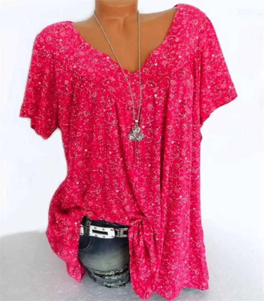 Women's summer top: "Celeste" floral print, V-neck, and delicate flutter sleeves.