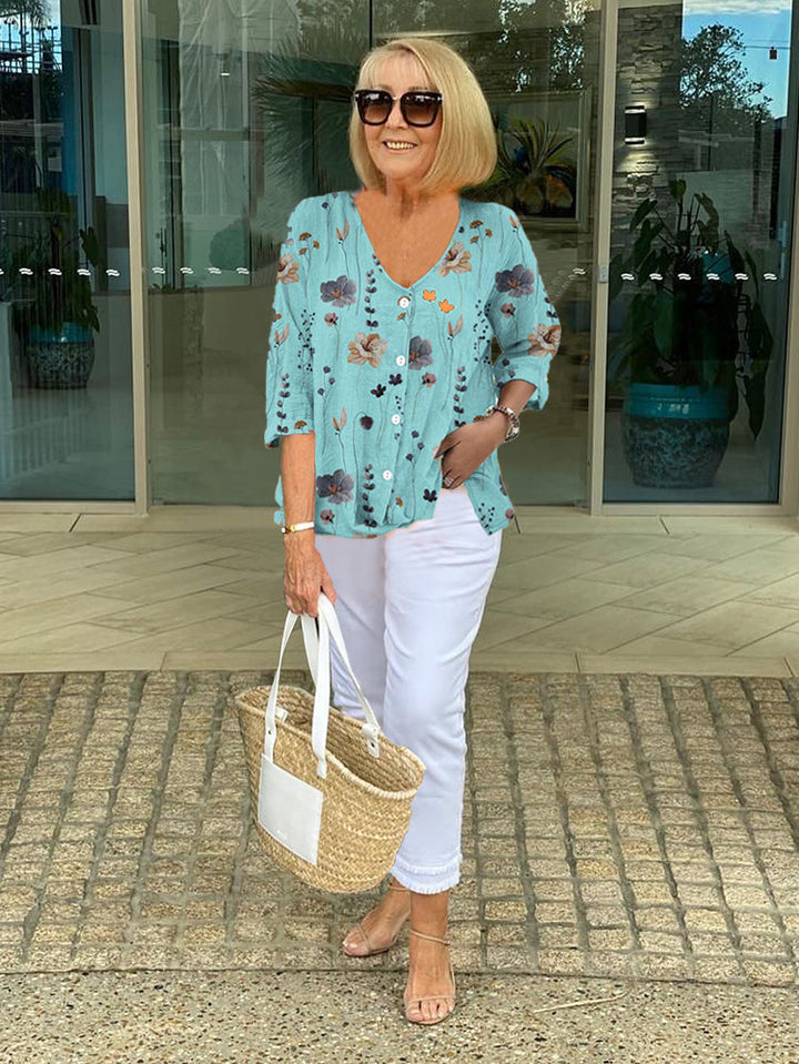Women's floral button-front blouse with V-neck & three-quarter sleeves. Perfect for spring & summer casual wear.