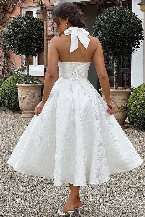 Chic women's floral wedding guest dress, A-line cut, midi length, halter style.