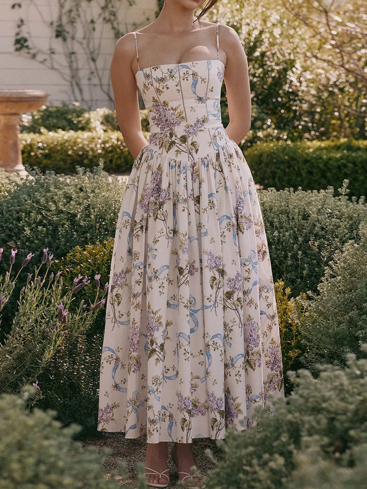 Blue floral print corset midi dress with strappy details, ideal spring or special occasion wear.