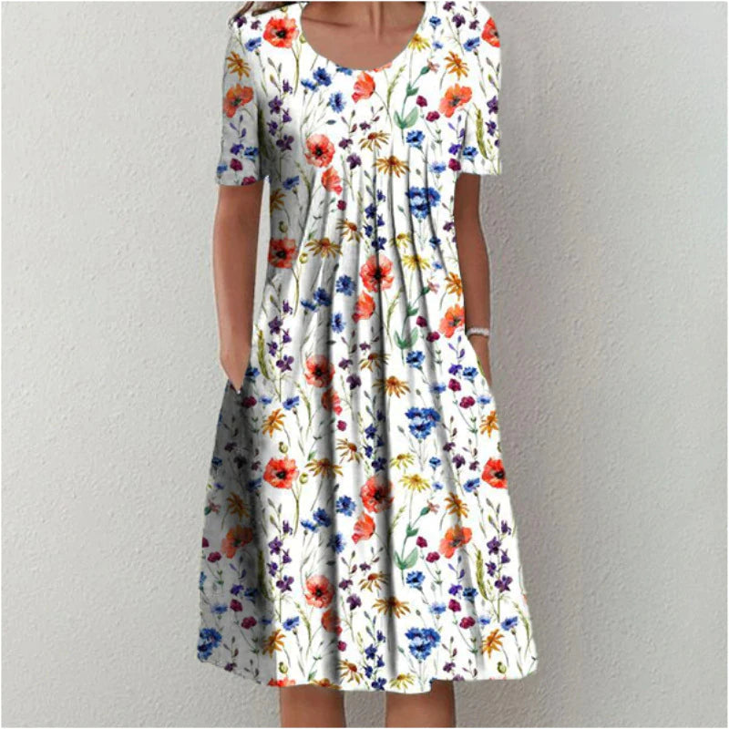 Women's floral midi dress with short sleeves, round neck, and practical pockets for casual wear.