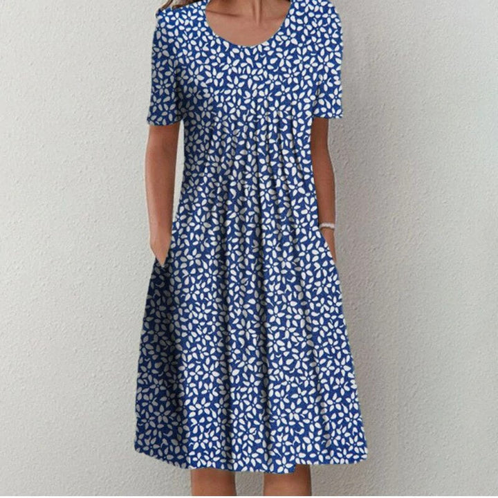 Stylish women's floral midi dress featuring short sleeves, a round neck, and a flowy fit for spring & summer.