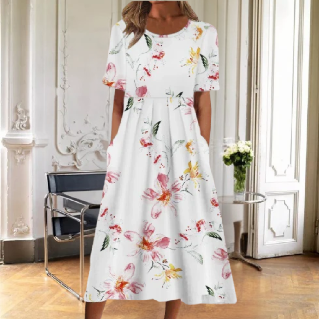 Comfortable women's short sleeve midi dress. Features a vibrant floral print, round neck, & elegant flared skirt.