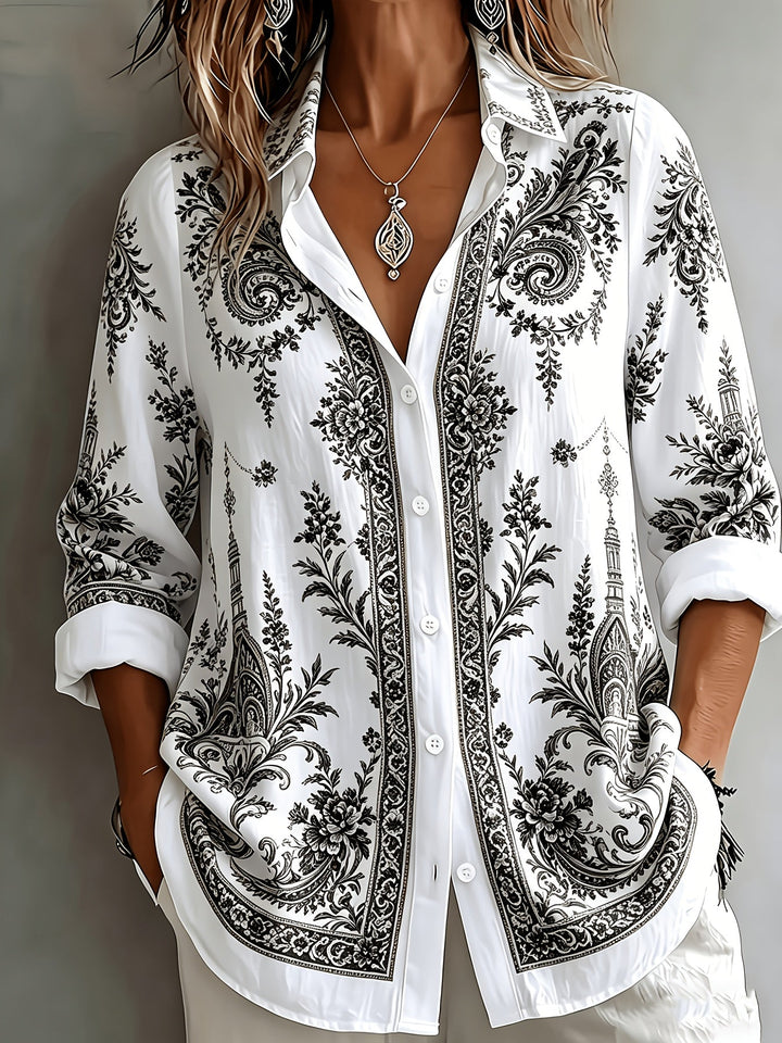 Casual women's long sleeve blouse with vibrant floral and paisley print design.